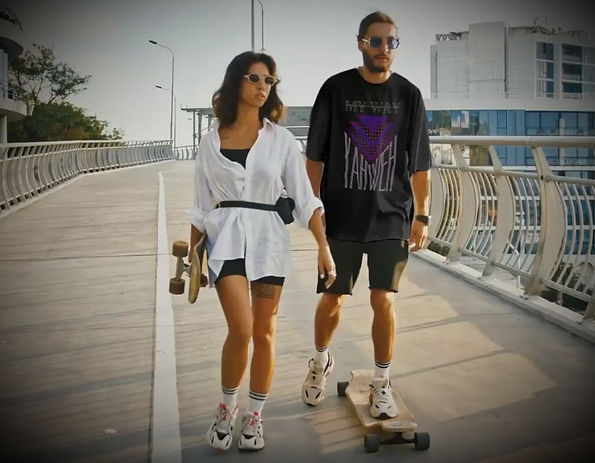 Man wearing Not My Way Yahweh shirt walking on boardwalk