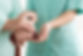 Close-up of woman using cane assisted by
