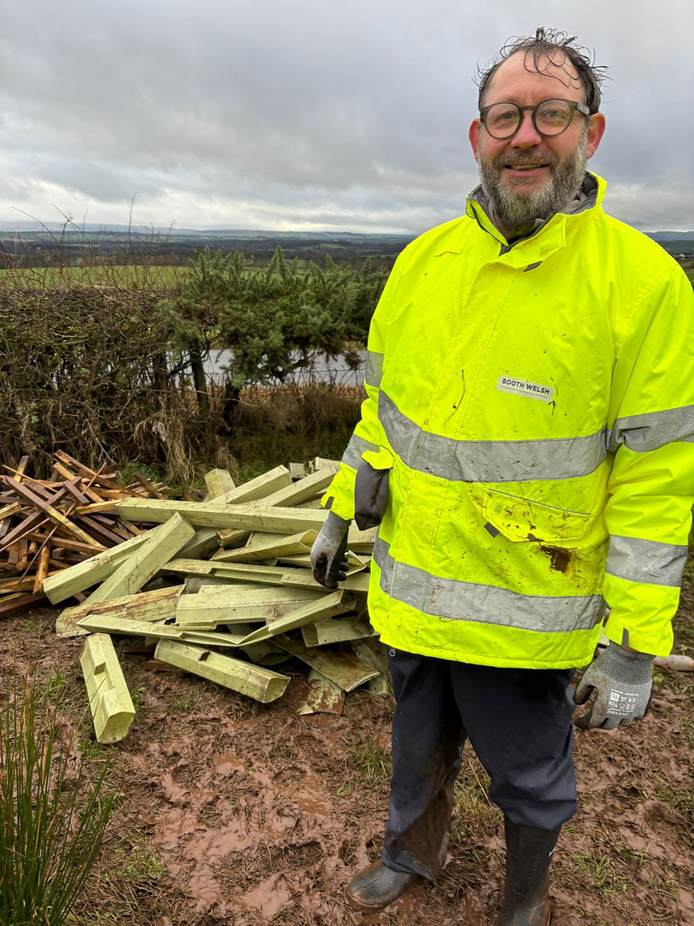 A soaked, but cheerful Bertil examines the team's efforts