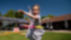 Little girl hula hooping in the sunshine.