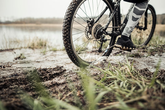 low-section-male-cyclist-riding-bicycle-mud.jpg