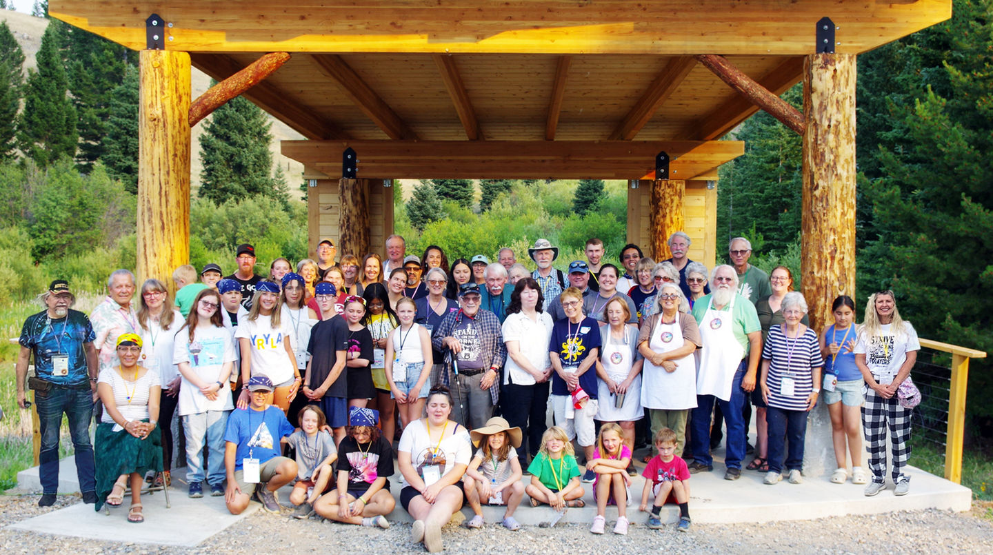 large group photo under wood canopy