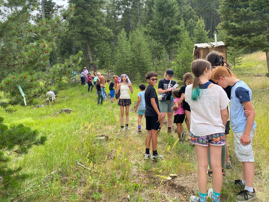 line of people on a trail looking in various directions