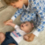 Big brother Nate Sheridan, son of PUSH Changemakers Fernanda & Chase Sheridan, playing with his baby sister Grace, born after losing their son George and daughter Natalie