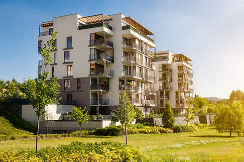 Modern block of flats in the green park. Eco-friendly living in a city..jpg