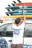 young surfer from Germany ready to have his surf equipment at the top of a car