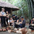 International tourists learning how to weave bamboo utensils with Thai Hai villagers