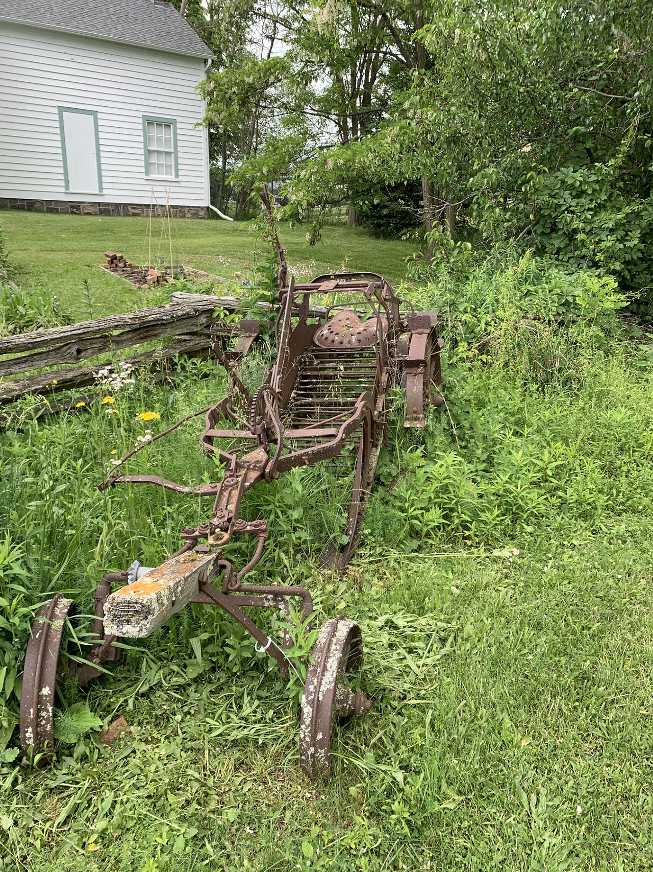 Potato Digger Covered in Weeds