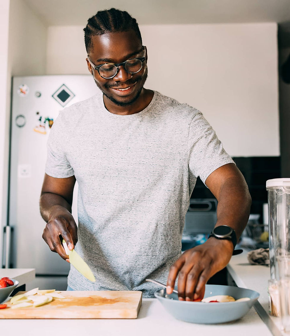 Man cutting vegetables in his kitchen