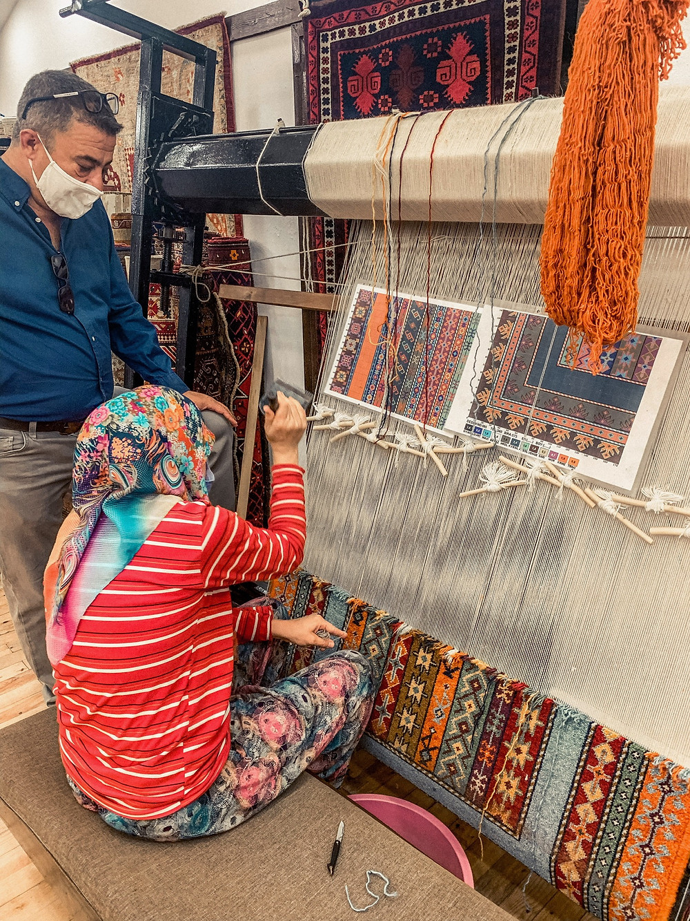 A master weaver creating a Turkish carpet, one knot at a time