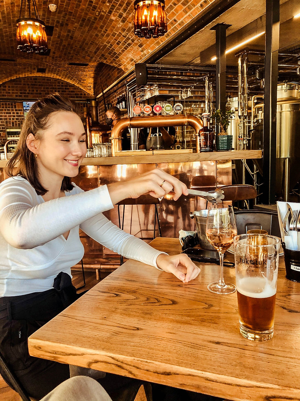 Jenna doing the wine thing and Chipp drinking a delicious Tuk Tuk "test beer"