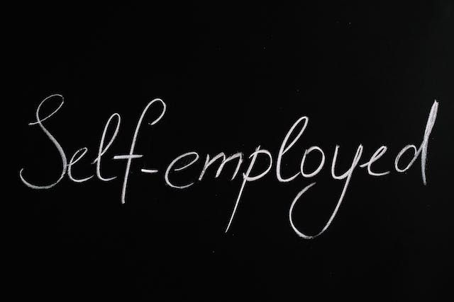 Words on a black board self-employed