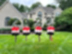 Thumbnail: 4 topiary stakes with big silver numbers 2024 on top. Base balloons in red, white and black
