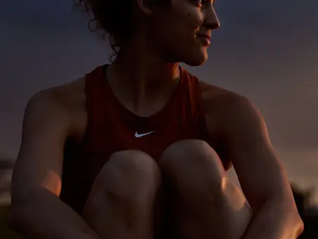 an athlete sitting, resting, with a thoughtful expression