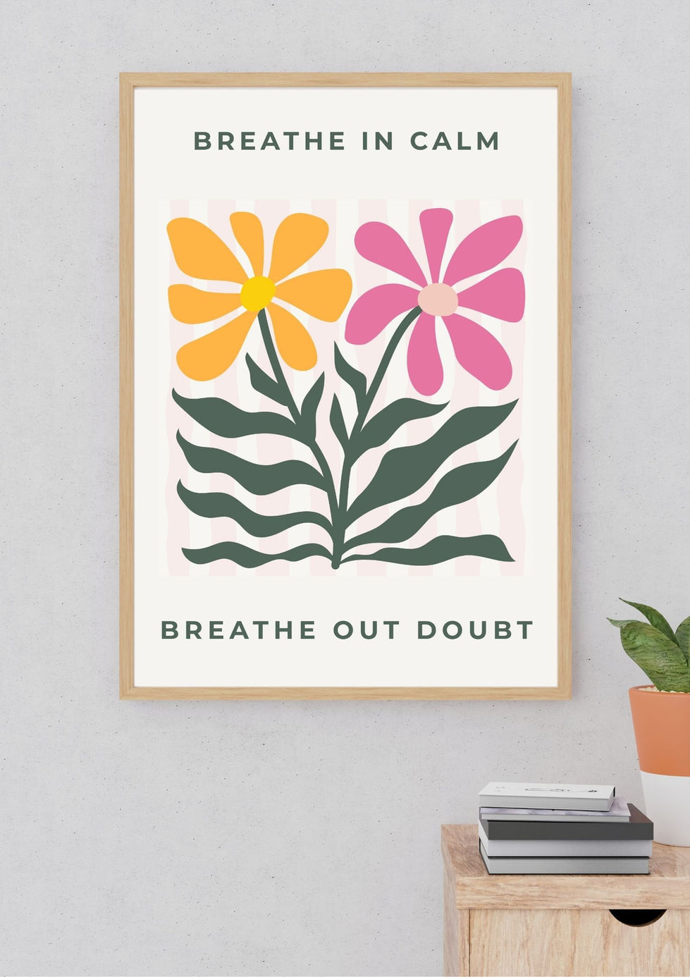 Framed floral poster with motivational text on wall.