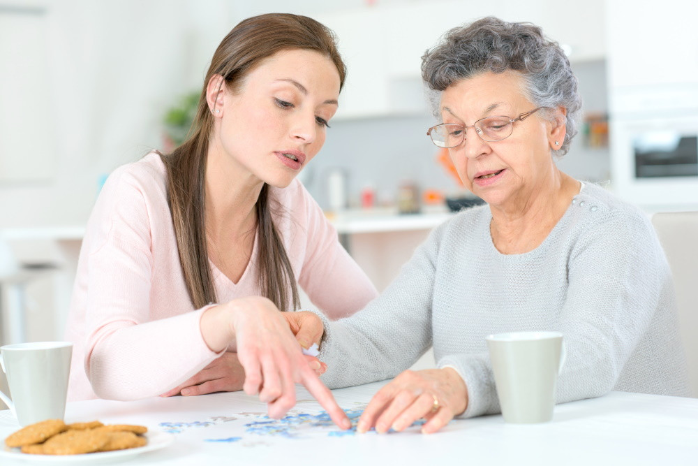 Adult daughter and her mother reviewing cost of assisted living facility