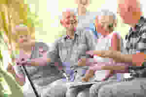 residents of a senior living community smiling and sitting together