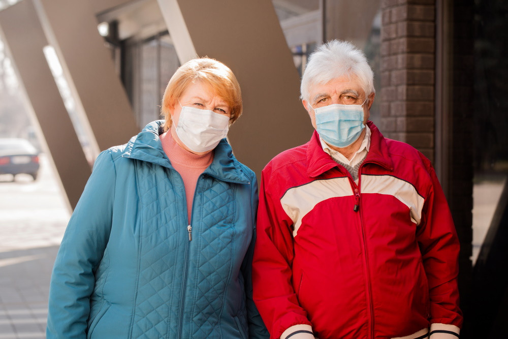 senior citizens wearing face masks outside a building