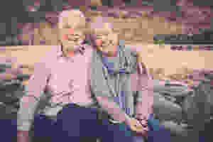 happy older couple sitting outside