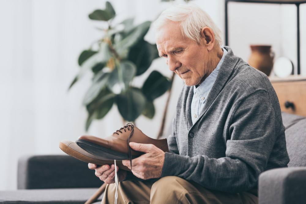 man with dementia looking at shoes