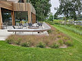 Seating area on deck with grasses- Garden and hardscape design by Spaces Landscape Architecture, Quogue, NY.