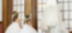 Two young girls look up at a wedding dress and dream of their own big day.