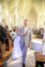 A couple leave the cathedral to enjoy their life together.
