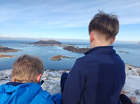 Children enjoying the view from a small mountain in Sommarøy, Northern Norway