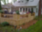 green treated wood deck w/ seating and planters