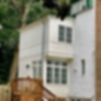 Exterior view of renovated porch area with larger windows and added architectural detail