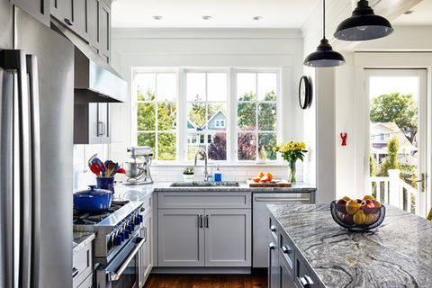 Contemporary kitchen with white cabinetry and stone countertops