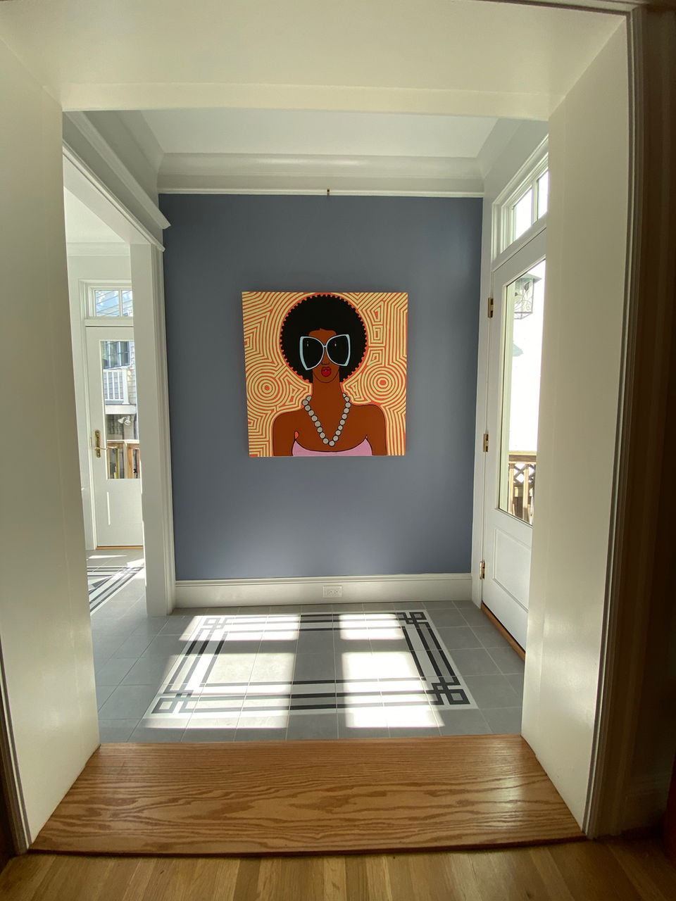View of modern artwork hanging on screened porch wall