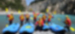 a group of kayakers pose by their boats on a new zealand river