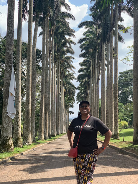 Xperience Black Founder Tamara Baynham at the palm tree rows in Aburi Botanical Garden in Ghana