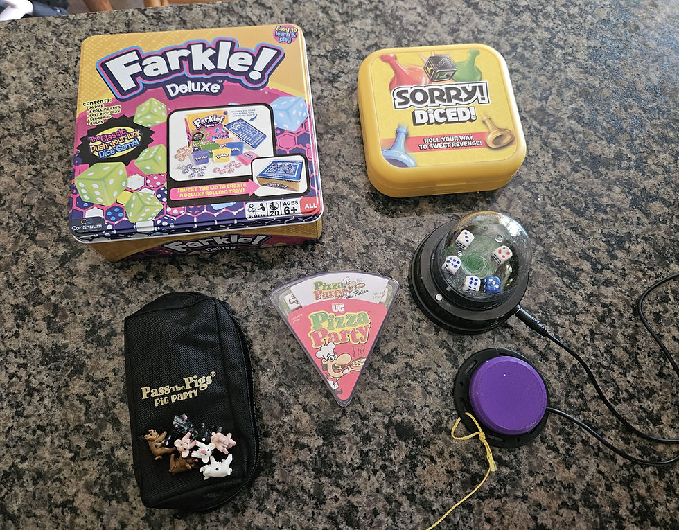a variety of board games and a dice roller on a marble counter