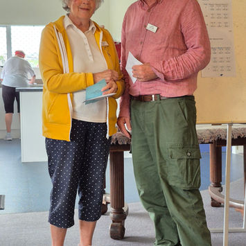 Woman accepts award from man at an event.