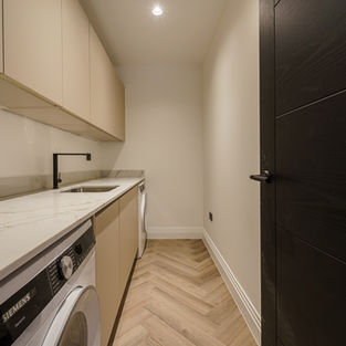 Utility room with built in storage and appliances
