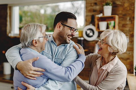 cheerful-senior-parents-having-fun-while-greeting-with-their-son-who-came-visit-them.jpg