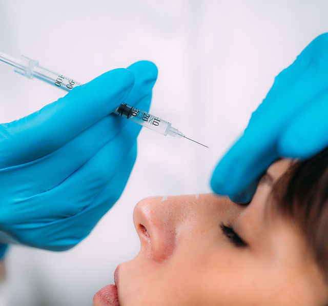 Dermal filler injection treatment. Doctor with surgical gloves injecting dermal filler int