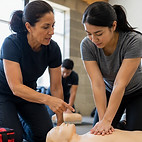 A female instructor providing one-on-one instruction to a student