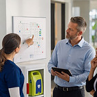 two people reviewing a map with local safety equipment locations