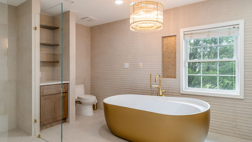Modern luxury bathroom with freestanding soaking tub and designer tile.