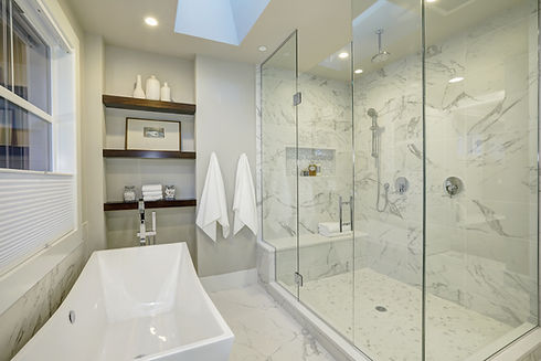 Amazing white and gray marble master bathroom with large glass walk-in shower, freestandin