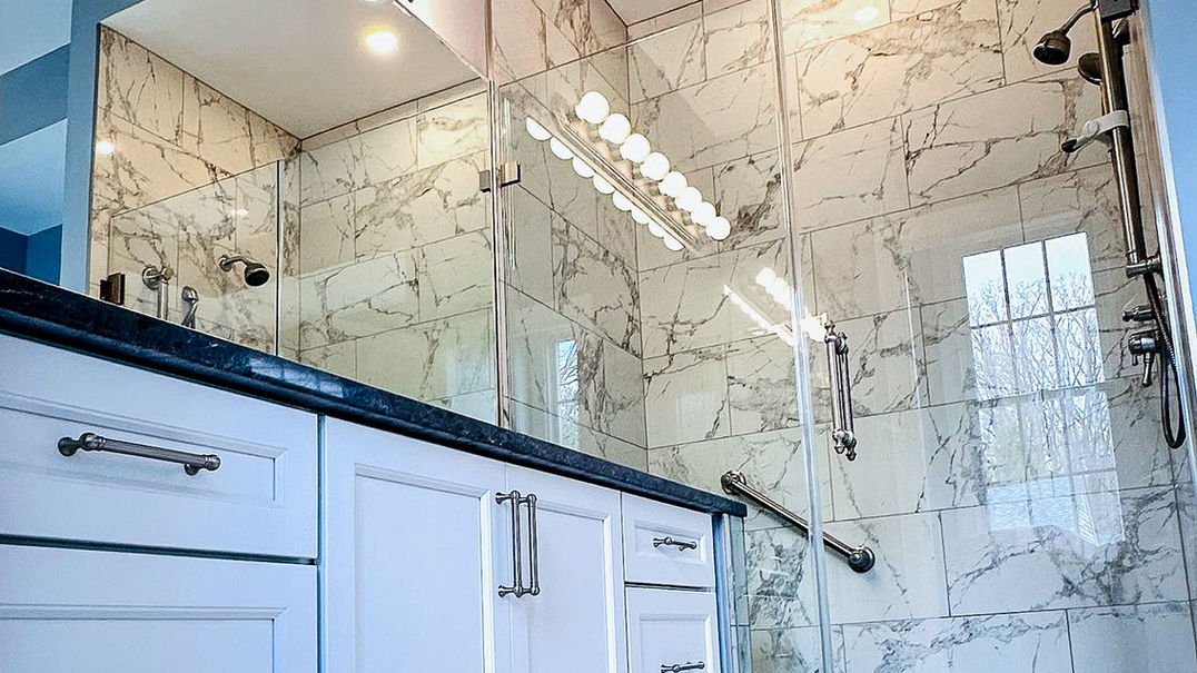 2025 master bathroom remodel with wood vanity and backlit mirrors. Harford County Bel Air
