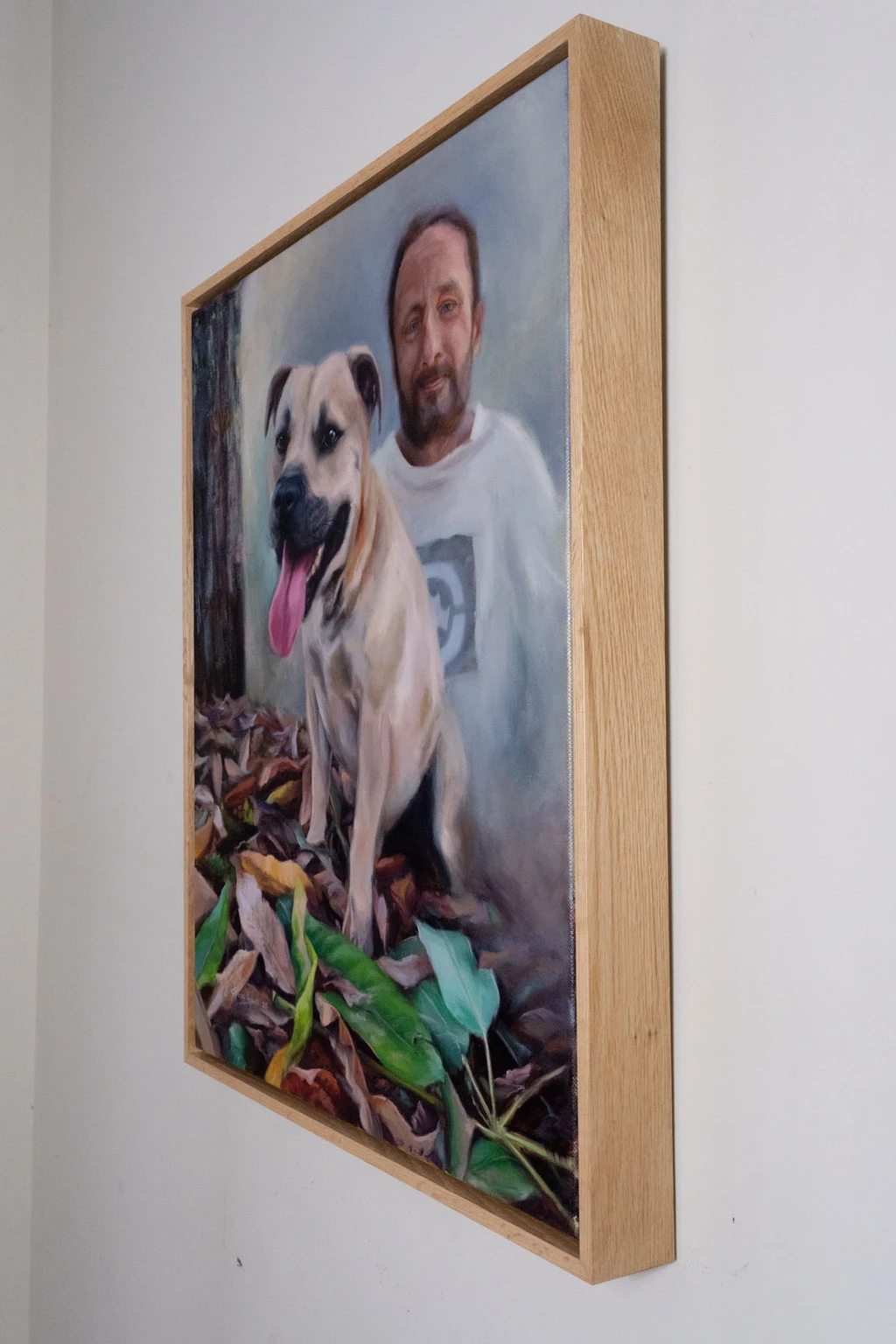 Finished custom dog portrait of Kovo framed in a sleek wooden floating frame.