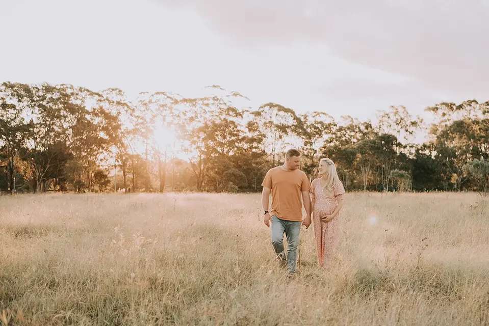 Expecting Couple in a Field