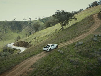 Amarok Ute driving up a steep dirt road in the hills