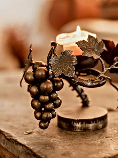 Grape Vine Candle Holder with a Lighted Candle