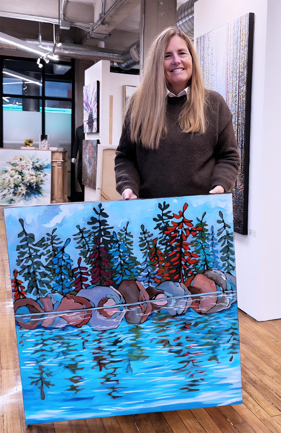 Lynda Flanagan - CANADIAN ARTIST - HOLDING ONE OF HER PAINTINGS

