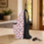 Left-side view of the Vintage Pink Cherry sling bag showing the adjustable black strap and side construction.